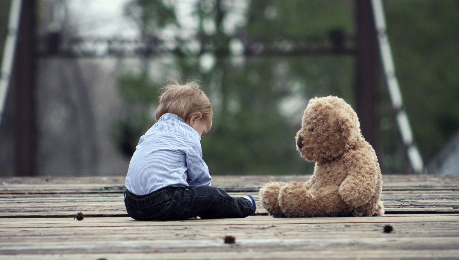 toddler-sitting-with-teddy-bear